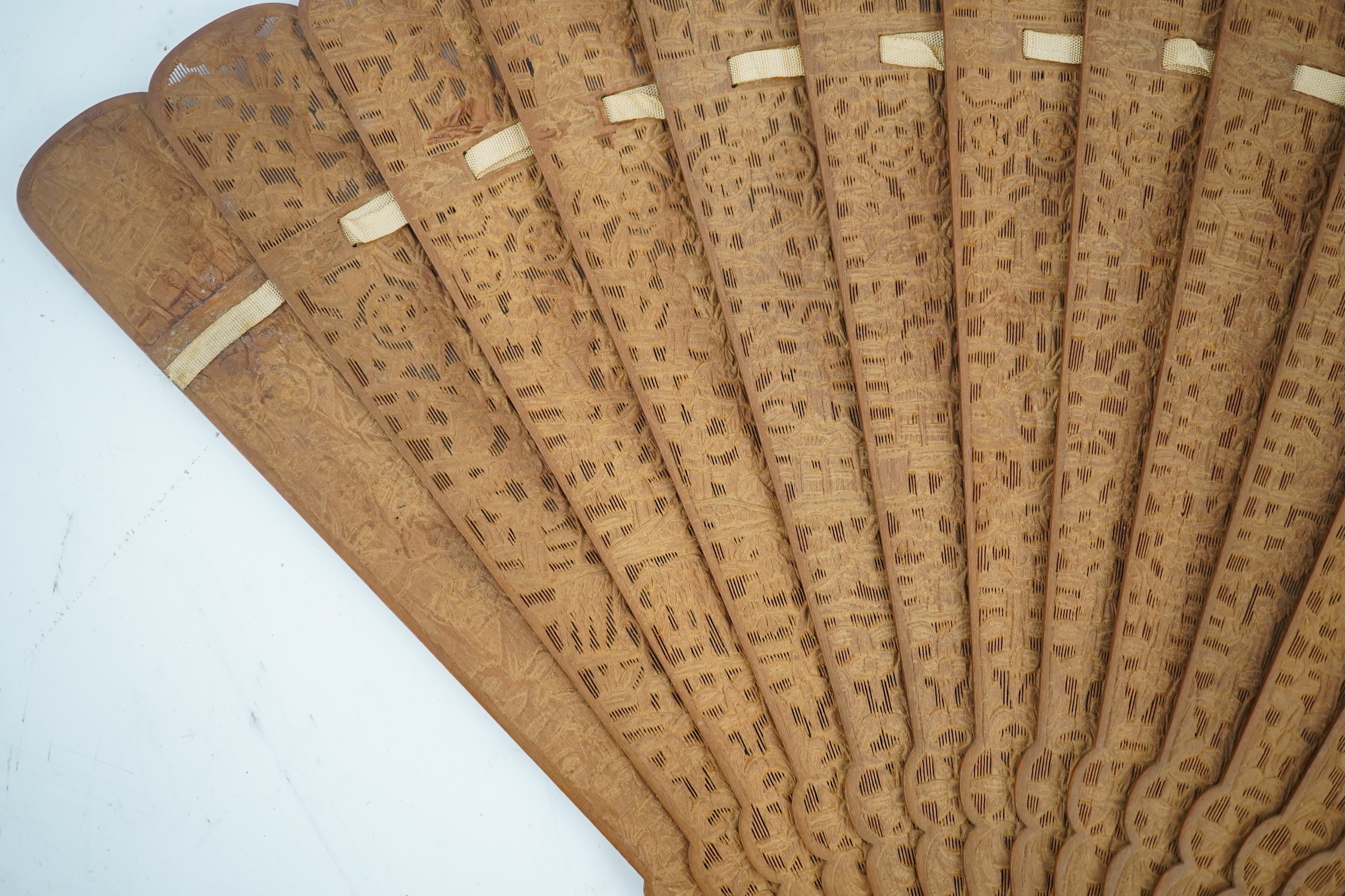 A fine Chinese sandalwood brise fan with finely carved sticks and guards, together with a mid 20th century silk calligraphic poetry LuYou fan, brise fan 38cm wide. Condition - minute damage to carving on one stick, sanda